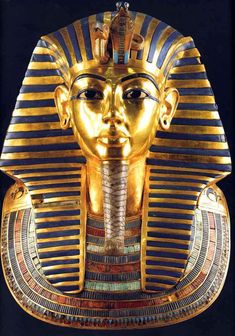 an egyptian mask is shown in gold and blue