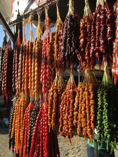 many different types of vegetables hanging from hooks