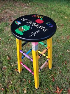 a stool made out of children's crayons in the grass