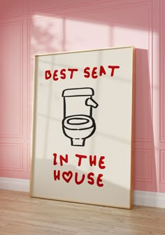 a bathroom sign with the words best seat in the house on it next to a pink wall