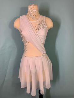 a female figure is wearing a pink dress with beading on the neck and shoulders