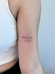 a woman with a small tattoo on her arm