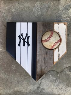 a baseball bat, ball and glove are in the shape of a triangle on a stone wall