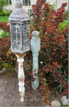 an old fashioned mailbox in front of some bushes