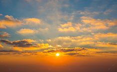 the sun is setting over the ocean with clouds in the sky - stock photo - images