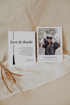 a graduation photo and thank card sitting on top of a white blanket with the words love & thanks written across it