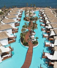 an aerial view of a resort pool and beach