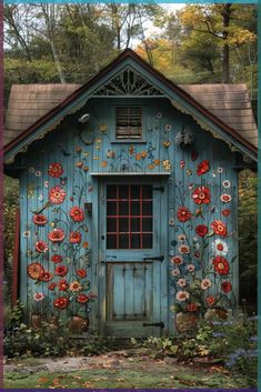 a blue shed with flowers painted on it