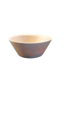 a wooden bowl sitting on top of a white wall