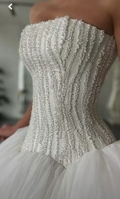 the back of a wedding dress with beading on it