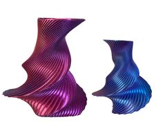 two colorful vases sitting next to each other on a white surface, one is purple and the other is pink