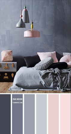 a bedroom with grey walls, pink and gray bedding, two lamps hanging from the ceiling