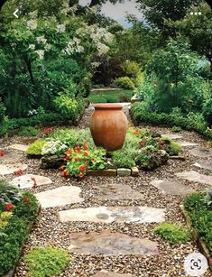 a large vase sitting in the middle of a garden