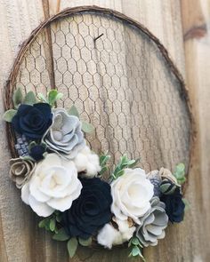 an image of a wreath made out of flowers on a wooden board with the text instagram