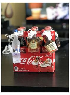 coca - cola bottles are sitting in a red box on a table