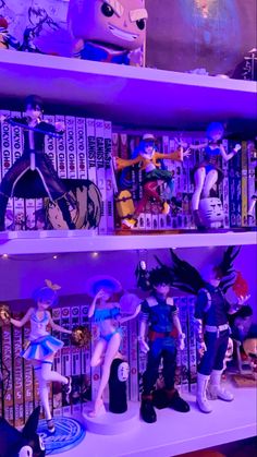 some anime figurines are sitting on shelves