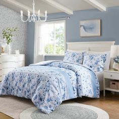 a bedroom with blue walls and white furniture