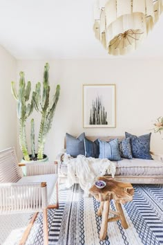 a living room filled with furniture and cactus plants