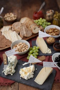 various types of cheese and crackers on a table