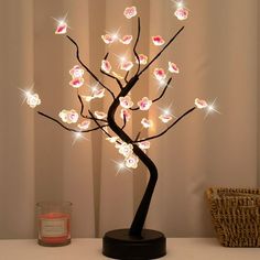 a lighted tree with pink flowers on it