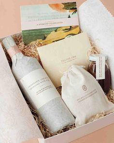 an open gift box containing two bottles of wine, soaps and lotion in it