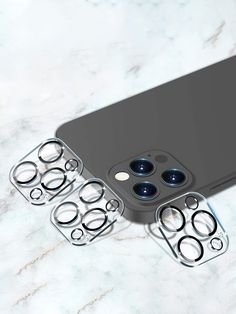 an iphone case with four camera lens holes on the front and back sides, sitting on a marble surface