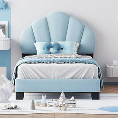 a bedroom with blue and white decor on the walls, flooring and bedding