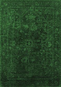 a green rug with an intricate design on the center and sides, in different colors