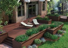 an outdoor deck with raised planters and lawn furniture