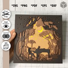 someone is holding up a laser cut card with the silhouette of a man and dog