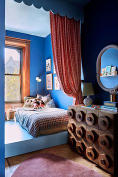 a bedroom with blue walls and pink carpet