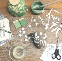 the table is covered with paper and crafting supplies