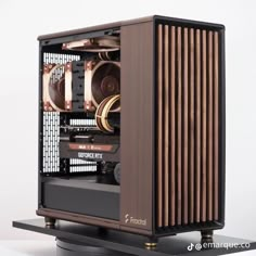 a computer case sitting on top of a black stand with gold trimmings and wooden slats