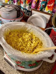 a large pot filled with noodles on top of a counter