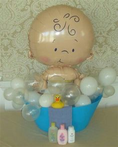 a baby in a tub filled with balloons