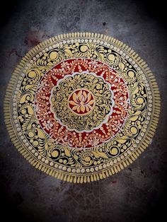 an intricately designed red and gold plate