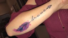 a woman's arm with an arrow and the word believe tattooed on her left arm