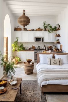 a bed sitting in a bedroom next to a table with food on top of it