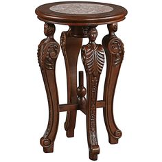 an ornate wooden table with marble top