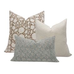 four pillows with different patterns on them, one in blue and the other in brown