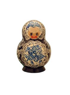 an ornately decorated russian nesting doll on a white background with blue and red flowers