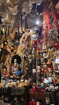 many masks and other items are on display in a store with lights shining from the ceiling