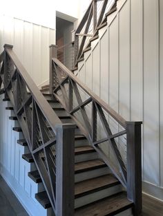 a wooden staircase with metal handrails in a house