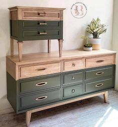 a green dresser with drawers and a potted plant on top