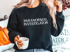 Paranormal Investigator - Sweatshirt Ideal for any Ghost Hunting Investigation, a unisex heavy blend crewneck sweatshirt is pure comfort. These garments are made from polyester and cotton. This combination helps designs come out looking fresh and beautiful. The collar is ribbed knit, so it retains its shape even after washing. There are no itchy side seams on these sweaters.  .: 50% cotton, 50% polyester .: Medium-heavy fabric (8.0 oz/yd² (271.25 g/m .: Loose fit .: Sewn-in label .: Runs true to size Special Ed Teacher, School Sweatshirts, Coffee Sweatshirt, Math Humor, Nurse Sweatshirt, Fun Sized, Dog Sweatshirt, Roller Derby, Mom Sweatshirt