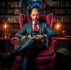 a man sitting in a red chair with his feet up on a book and wearing a suit