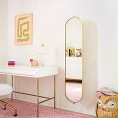 a white desk with a mirror on it and a chair next to it in a room