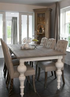 a dining room table with chairs around it