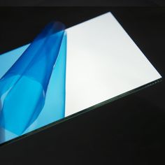 a blue and white glass table top with an abstract design on the edge, in front of a black background