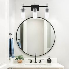 a bathroom with a sink, mirror and towel rack